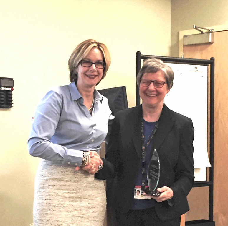 Sharon-Lise Normand, left, accepts award from L. Adrienne Cupples, Harvard SPH professor of biostatistics.